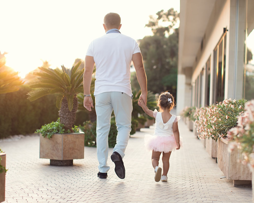 Parent And Child Walking Together - Baker Wealth Group