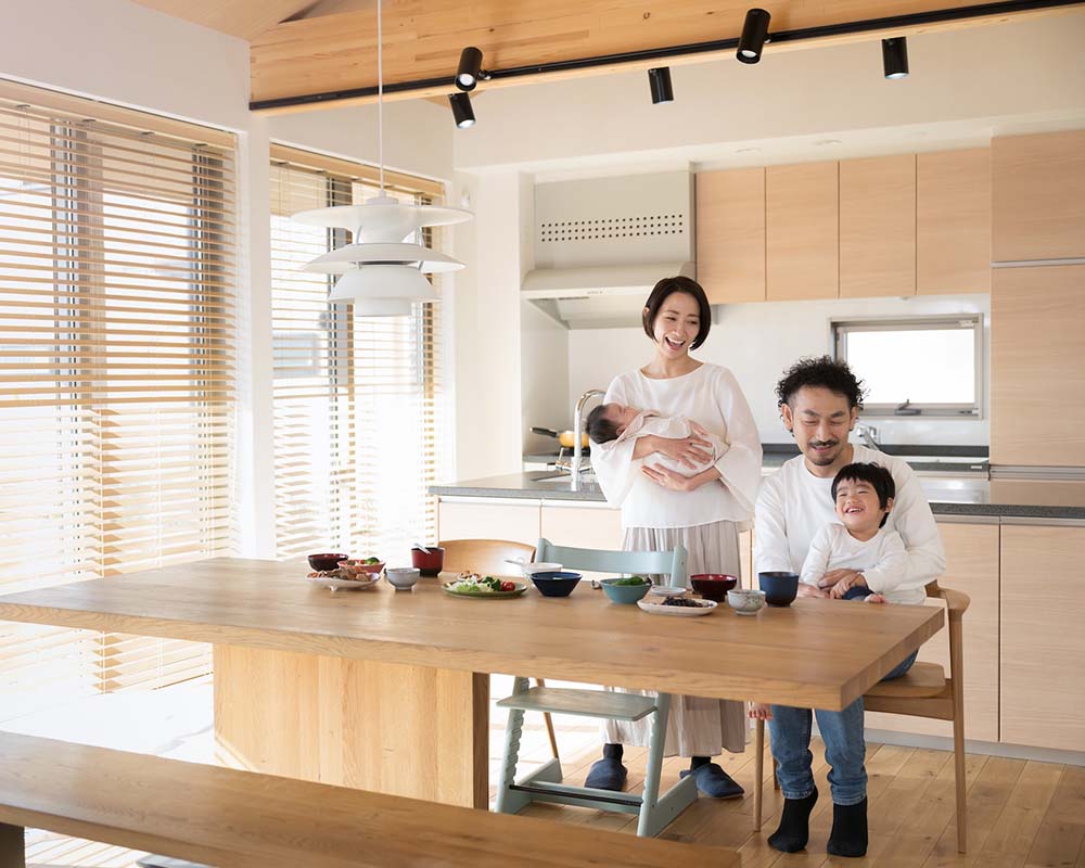 Family Smiling Together In Kitchen - Baker Wealth Group